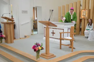 Archbishop pours consecrated oil on the Altar